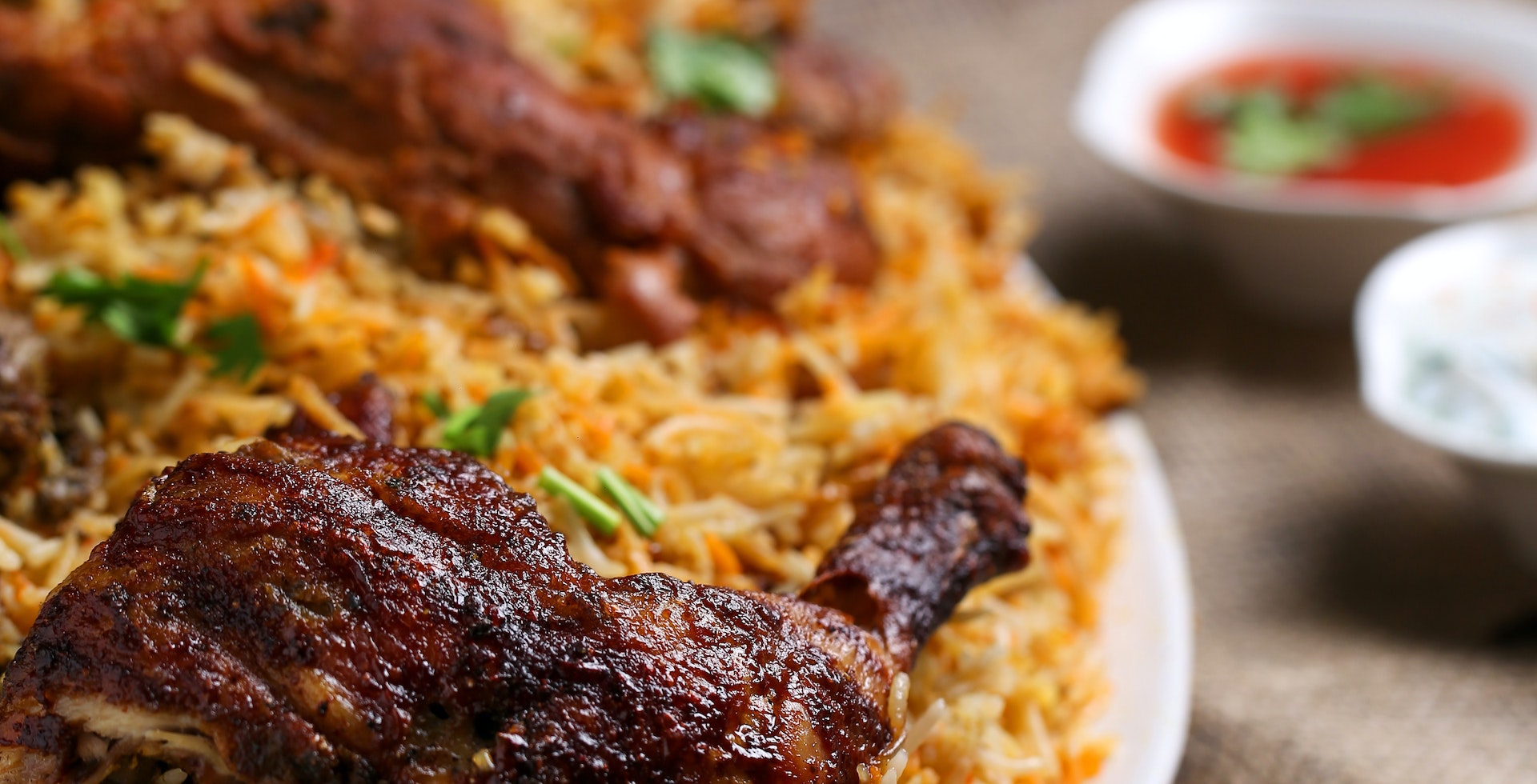 plate of biryani with a piece of chicken